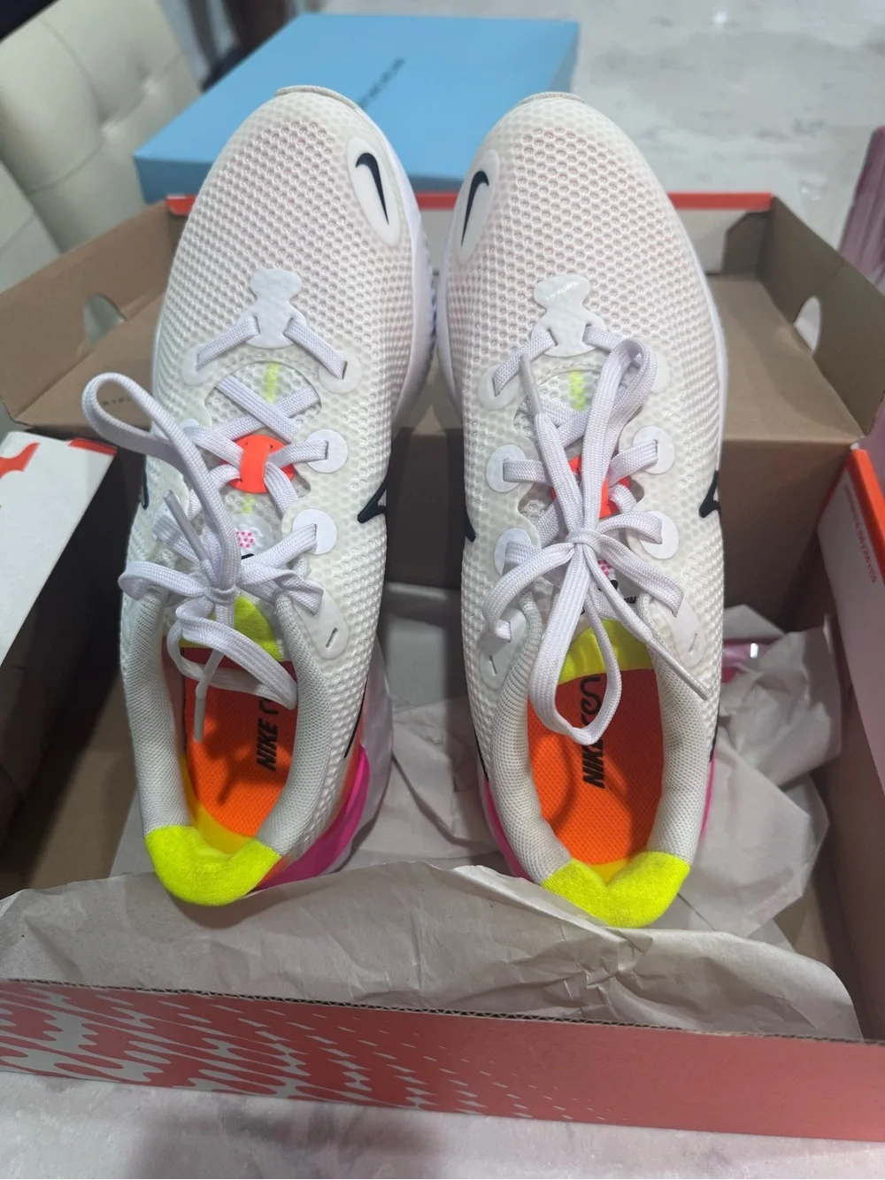 Nike White Running Shoe with Pink and Orange Accents